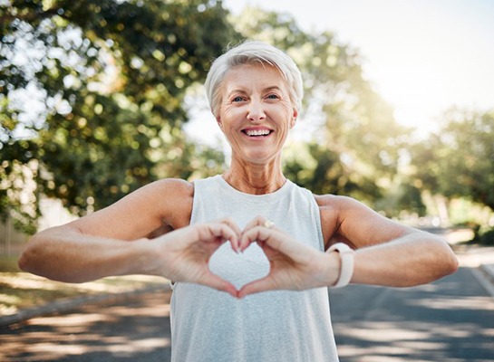 Lady makes shape of a heart with her hands