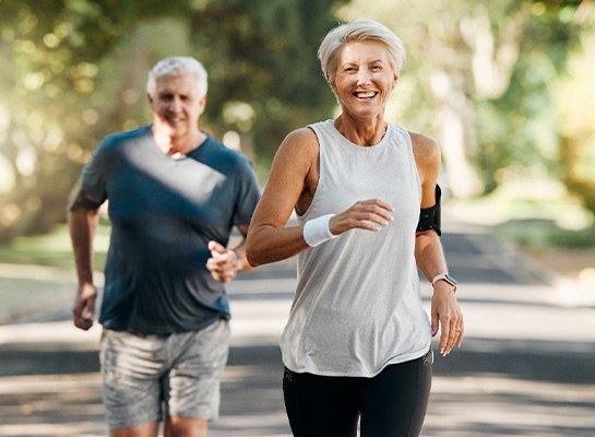 Couple smiling while running outside