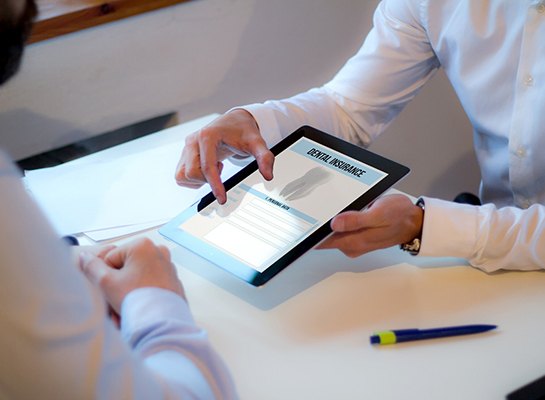 Patient reviewing dental insurance form on tablet