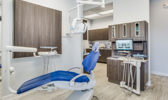 Woman in dental chair grinning at her dentist