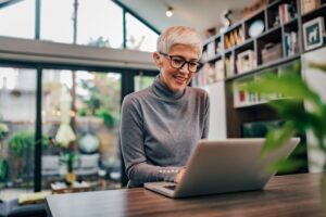 Woman with dental implants smiling at work