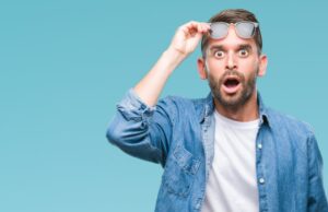 Man shocked and lifting his glasses up