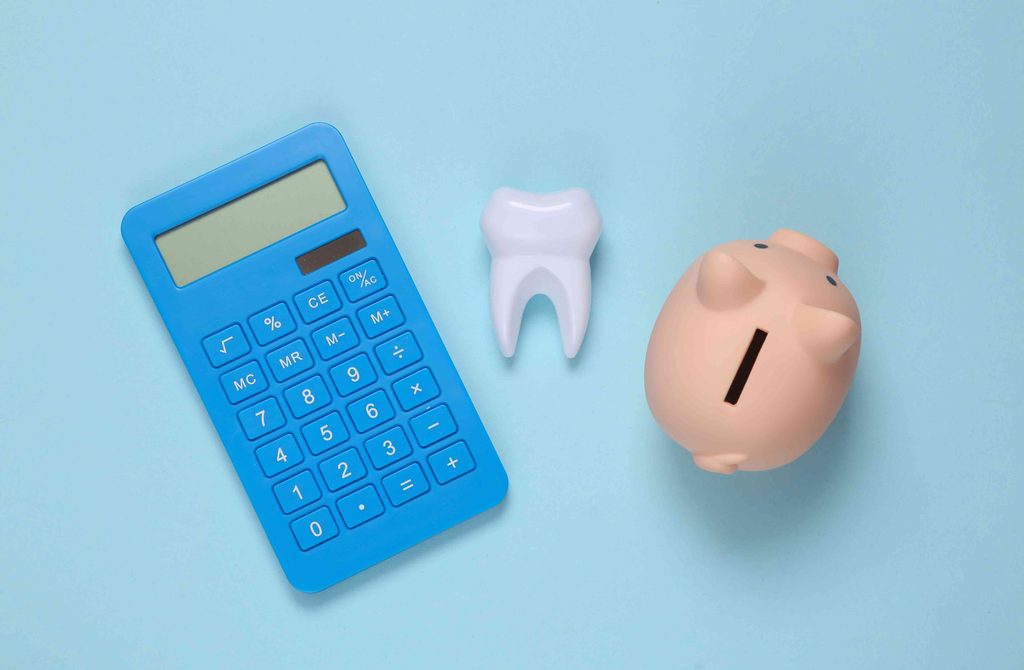 Piggy bank, tooth, and calculator